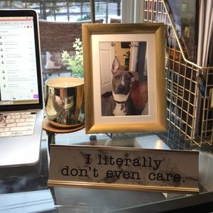 Desk sign reads “I literally don’t even care”